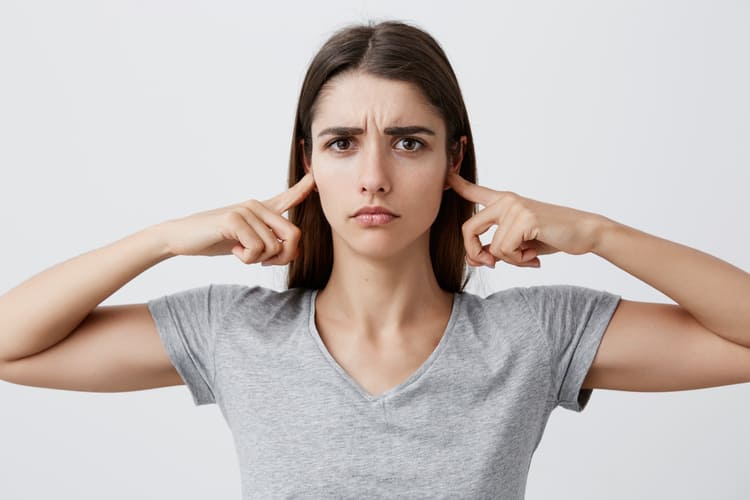 i-want-listen-you-anymore-young-beautiful-unhappy-caucasian-girl-with-long-brown-hair-gray-shirt-clothing-ears-with-hands-with-tired-sad-expression (1)